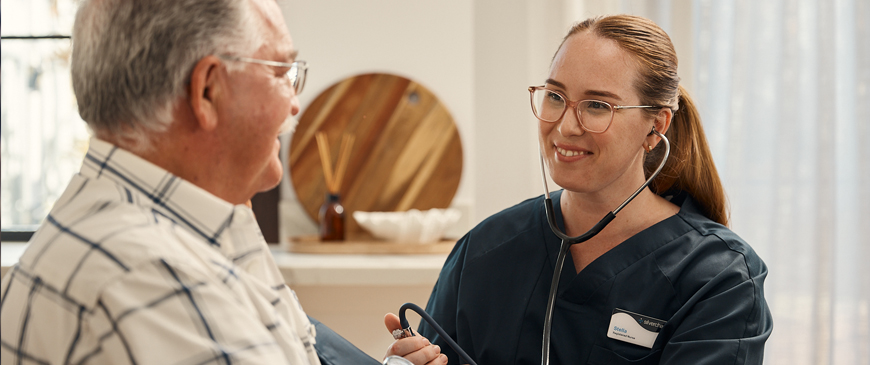 A Silverchain nurse smiles at a patient